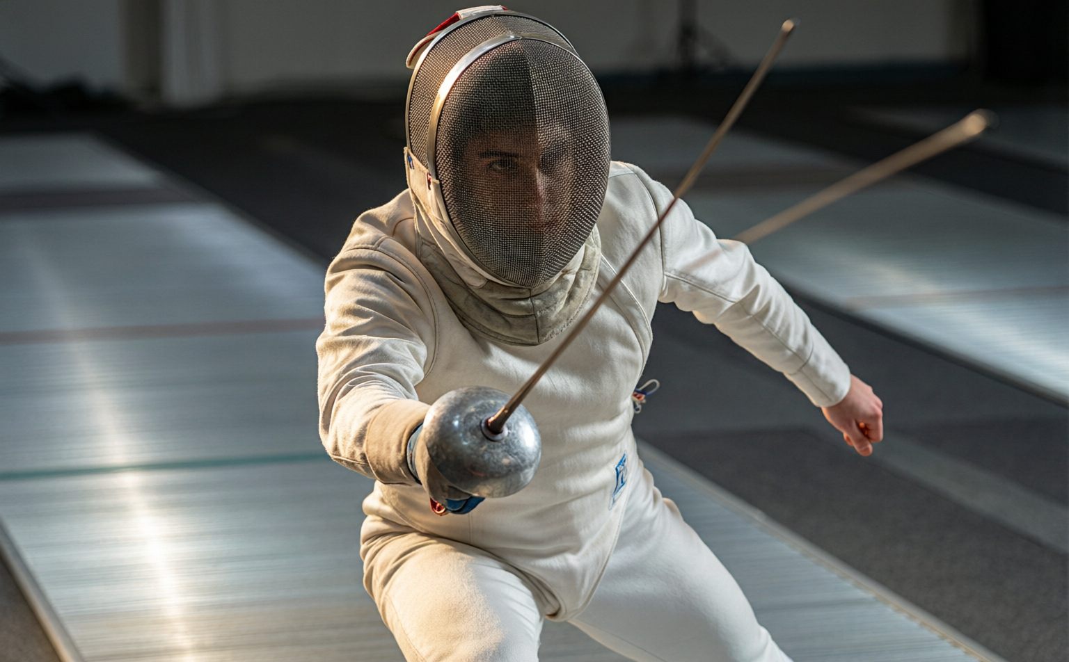 Fencer lunging on the piste